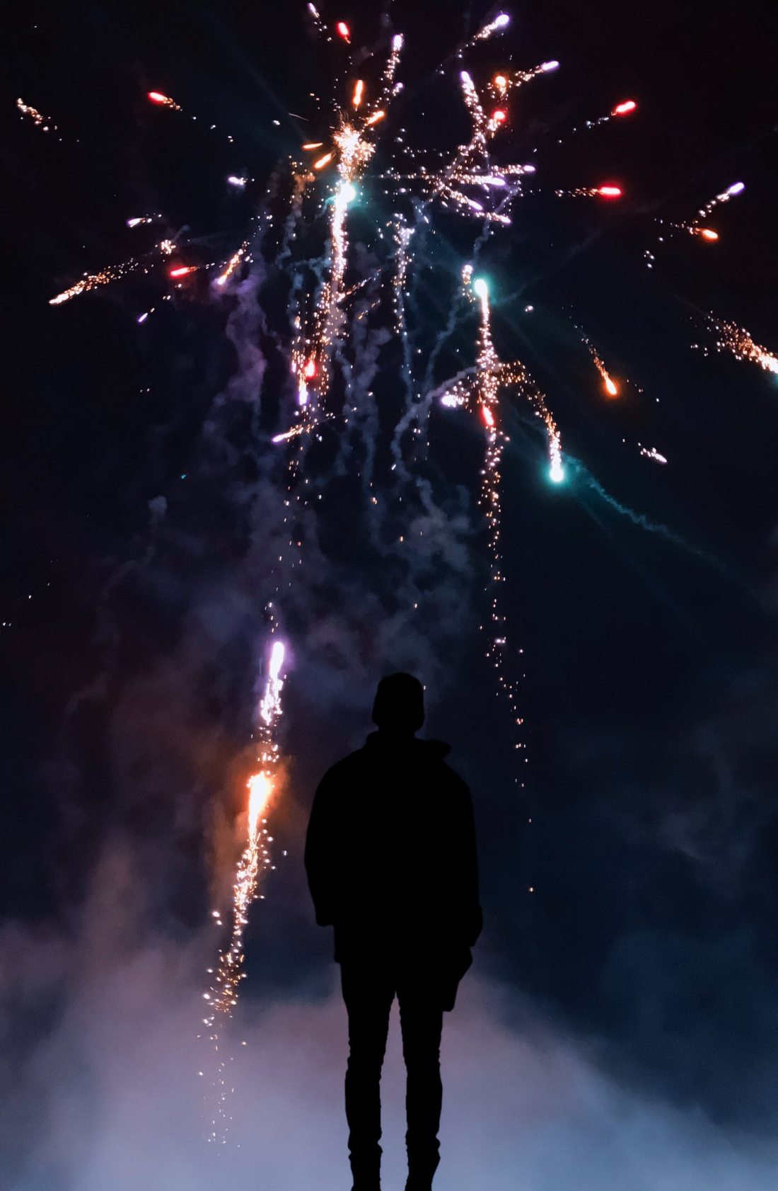 silhouette-of-person-in-front-of-fireworks-2297472